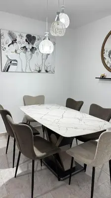 a dining room with a white table and chairs at New and Comfortable Apartment in Ciudad Juan Bosch in San Isidro