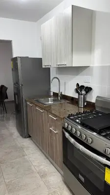 a kitchen with a stove and a sink at New and Comfortable Apartment in Ciudad Juan Bosch in San Isidro