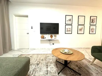 a living room with a table and a tv at New Jacuzzi Beach Fun 2 bedroom at Cana Rock Star in Punta Cana