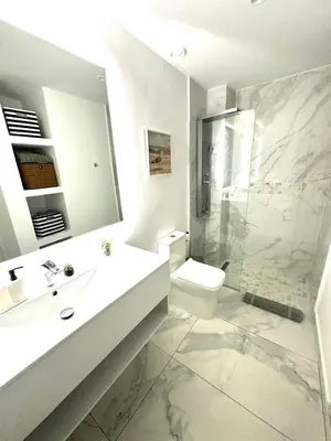 a bathroom with a sink and a toilet and a shower at New Jacuzzi Beach Fun 2 bedroom at Cana Rock Star in Punta Cana