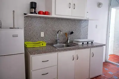 a kitchen with a sink and a refrigerator at Villa La Olita in La Puntica de Juan Dolio