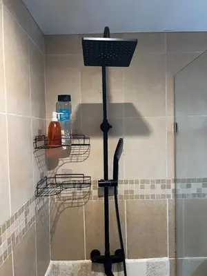 a shower with a basket on the corner of a bathroom at Cozy 3 Bedroom Apartment with Pool & Private Beach in Bávaro Punta Cana in Punta Cana