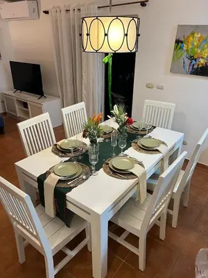 a white table with white chairs and a white dining room at Cozy 3 Bedroom Apartment with Pool & Private Beach in Bávaro Punta Cana in Punta Cana