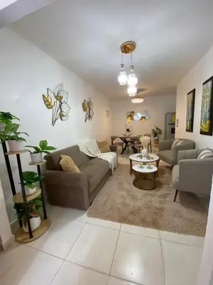 a living room with a couch and a table at Isidro 102 Comfrot Stay in San Isidro
