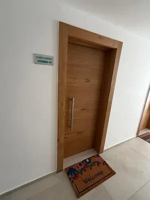 a wooden door in a room with a rug at Mila Apartment in Bayahibe