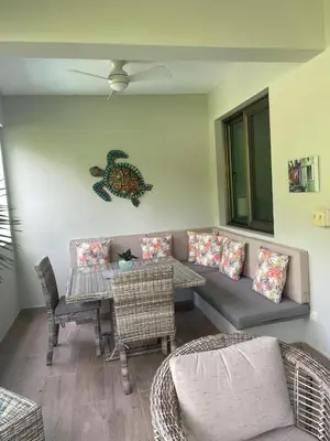 a living room with a couch and a table and chairs at Pro Cab Apartment - Washer - BBQ in Cabarete