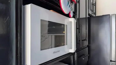 a microwave oven with the door open on a wall at One Bedroom Apartment - Wi-Fi - BBQ in Sosúa
