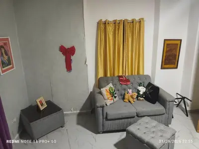 a living room with a couch with two stuffed animals on it at housing Freddy in Santo Domingo