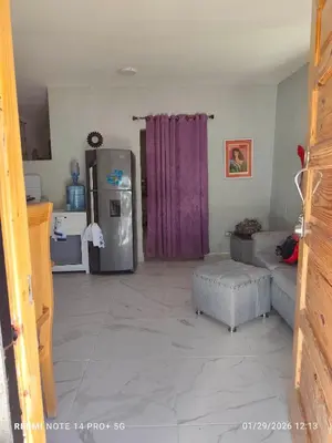 a living room with a refrigerator and a couch at housing Freddy in Santo Domingo