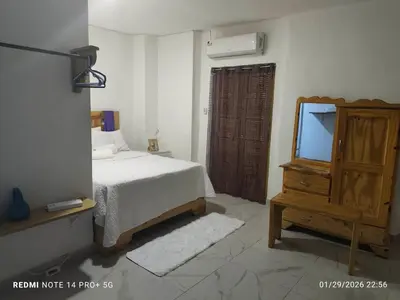 a bedroom with a bed and a dresser and a mirror at housing Freddy in Santo Domingo