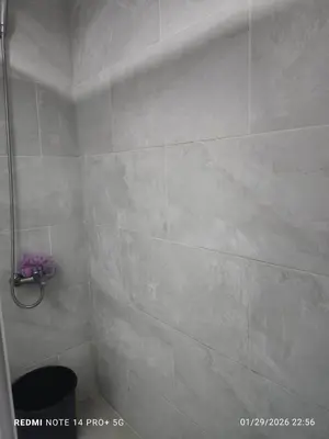 a bathroom with a tiled shower with a toilet at housing Freddy in Santo Domingo
