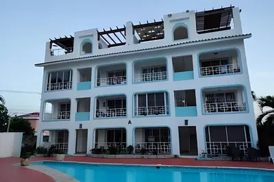 a building with a pool in front of it at Los Corales Moderno Apto: Piscina y Playa 10 min in Punta Cana