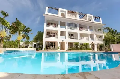 a large white building with a large swimming pool at Los Corales Moderno Apto: Piscina y Playa 10 min in Punta Cana