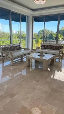 a living room with couches and tables and windows at Luxurious 3-Bedroom Apartment in Juan Dolio with Pool Access in Juan Dolio