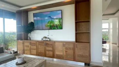 a living room with a flat screen tv on a wall at Luxurious 3-Bedroom Apartment in Juan Dolio with Pool Access in Juan Dolio