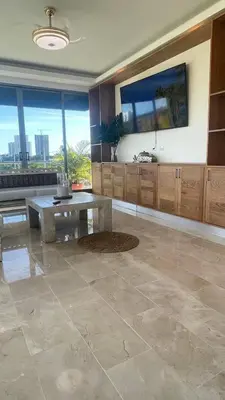 a large living room with a table and large windows at Luxurious 3-Bedroom Apartment in Juan Dolio with Pool Access in Juan Dolio