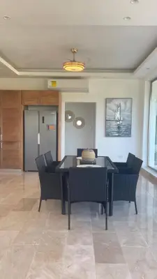 a dining room with a black table and chairs at Spacious 3-Bedroom Apartment with Pool Access in Juan Dolio in Juan Dolio