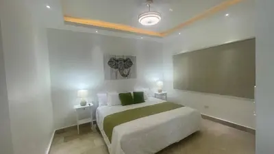 a bedroom with a large bed with two night stands at Spacious 3-Bedroom Apartment with Pool Access in Juan Dolio in Juan Dolio