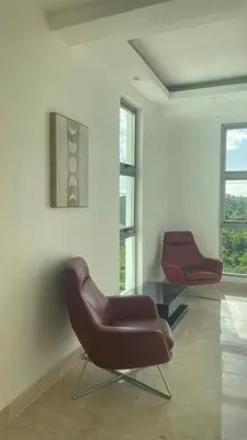 a living room with two chairs and a table at Spacious 3-Bedroom Apartment with Pool Access in Juan Dolio in Juan Dolio