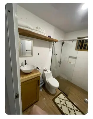a bathroom with a toilet and a sink and a shower at Villa Manuel Rodriguez