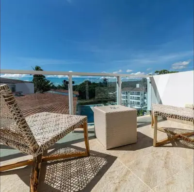 a balcony with two chairs and a table at Presidential Suites 1 bedroom with kitchen in Cabarete