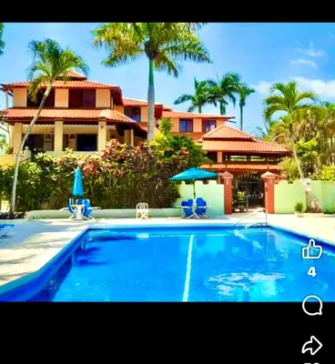 a large swimming pool in front of a house at Cita Del Sol in Cabarete