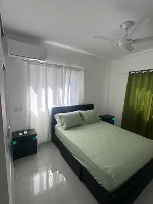 a bedroom with a bed and a ceiling fan at Beach front apartment in Puerto Plata