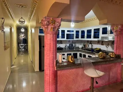 a kitchen with a large island in a room at Recidencial Laurel in Baní