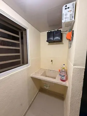 a small bathroom with a sink and a window at Super Apartment 10 mn to the Int Airport
