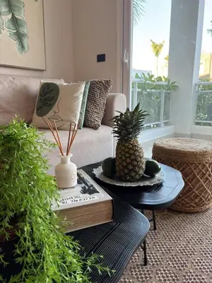 a living room with a couch and a coffee table with a pineapple at Garden Breeze Pool & Beach Escape l Bali 102 in La Laguna