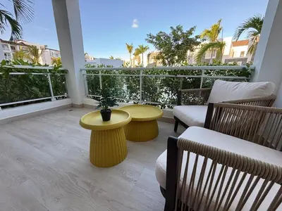 a living room with two chairs and a yellow table at Garden Breeze Pool & Beach Escape l Bali 102 in La Laguna