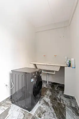 a washing machine in a room with a counter at Oz Residence Beach Two-Bedroom Apartment & Free Parking