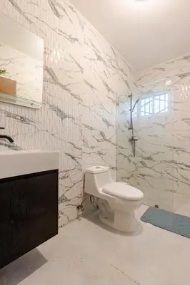 a bathroom with a toilet and a sink at Oz Residence Beach Two-Bedroom Apartment & Free Parking