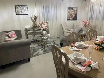 a living room with a table and chairs and a couch at My Little House in Constanza