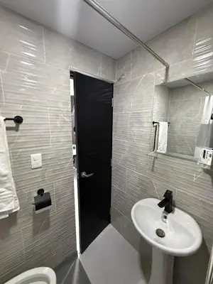 a bathroom with a white sink and a toilet at Moon Apartamentos C1 in San Cristóbal
