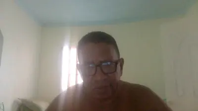 a man wearing glasses standing in a room at Fresh