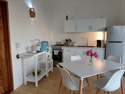 a kitchen with a white table and white appliances at Apartment Mariquita in Las Terrenas