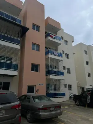 a large building with cars parked in a parking lot at Garden view paradise La Vega in Concepción de La Vega
