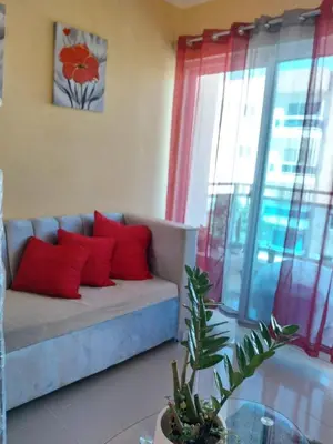 a living room with a couch with red pillows at Garden view paradise La Vega in Concepción de La Vega