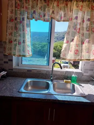 a kitchen sink in front of a window at Garden view paradise La Vega in Concepción de La Vega