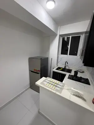 a white kitchen with a sink and a refrigerator at Moon Apartamento C2 in San Cristóbal