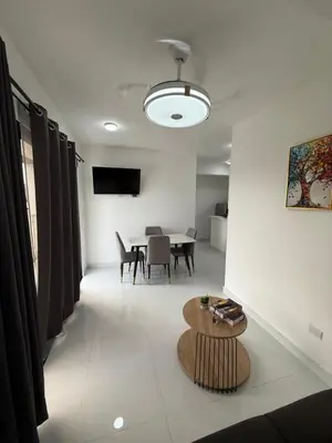 a living room with a table and a dining room at Moon Apartamentos D2 in San Cristóbal
