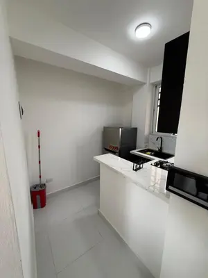 a white kitchen with a counter and a microwave at Moon Apartamentos D2 in San Cristóbal