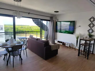 a living room with a couch and a table at Brisa del Mar Punta Cana Apartment in Punta Cana