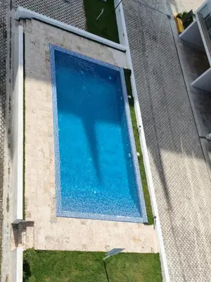 an overhead view of a swimming pool with a persons shadow at Brisa del Mar Punta Cana Apartment in Punta Cana