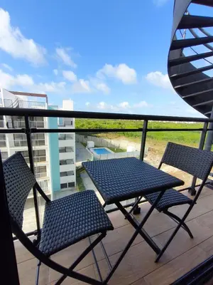 a pair of chairs and a table on a balcony at Brisa del Mar Punta Cana Apartment in Punta Cana