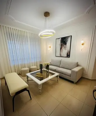 a living room with a couch and a table at Residencial ambar lll in Santiago de los Caballeros