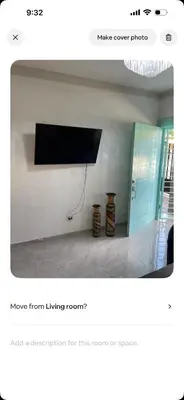 a living room with a flat screen tv on a wall at Lissette altagracia in Concepción de La Vega