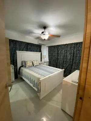 a bedroom with a bed and a ceiling fan at Departamento en la playa de palenque in Sabana Grande de Palenque