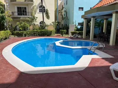 a swimming pool in a patio with a house at Escapada Perfecta Piscina 5 Min a la Playa in Punta Cana